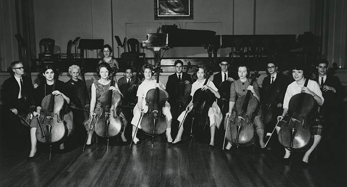 Group of musicians, mostly cellists. Historical photo.